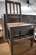 A 19th Century oak solid seat dining or hall chair having rail back