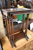 An Edwardian mahogany nest of three occasional tables, having gadrooned edge and turned column
