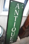 A painted 'Antiques' sign, approx. 137 x 46cm