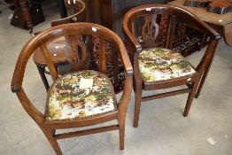 A pair of early 20th Century elbow chairs having hunting themed upholstery