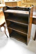 A dark stained Priory style low bookshelf, width approx. 61cm