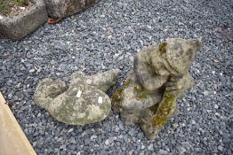 Two reconstituted garden ornaments, sleeping cherbub and elf/goblin interest