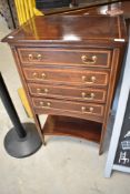 An Edwardian mahogany and inlaid four drawer music cabinet with undershelf, height approx. 92cm