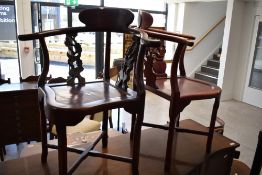 A pair of Oriental hardwood corner chairs