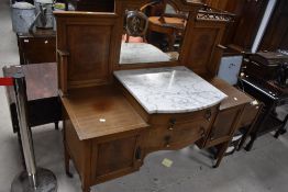 An Edwardian mahogany washstand having mirror back and raised marble top center , width approx.