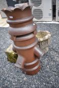 An unusual salt glazed Victorian chimney pot having crown top and vents, height approx. 99cm