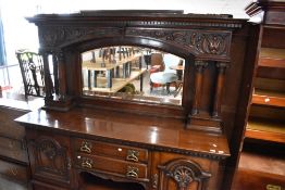 An impressive Victorian oak mirror back sideboard havung carved decoration and column supports ,