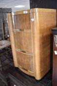 An Art Deco satin walnut three drawer bedside chest