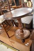 A 19th Century mahogany occasional table having circular top and base, with three claw feet