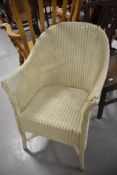 A vintage Lloyd loom tub chair in cream
