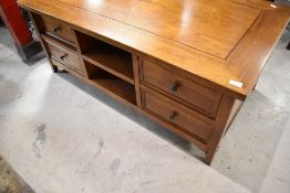A modern hardwood coffee table with undershelf and double sided drawer storage, possibly Laura