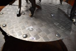 A checker plate garden table of circular form, diameter approx. 92cm