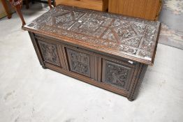 A late 19th or early 20th Century kist of nice proportions having heavily carved decoration, width