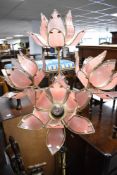 A vintage Hollywood style brass standard lamp having lotus design