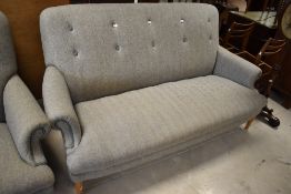 A modern three seater settee by Peter Hall, upholstered in grey tweed