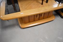 A modern coffee table having parque style and smoked glass top, approx. 127 x 75cm