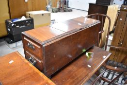 A Victorian mahogany composite storage book having central lidded compartment and drawers to end,