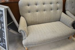 A modern two seater settee by Peter Hall, upholstered in grey tweed