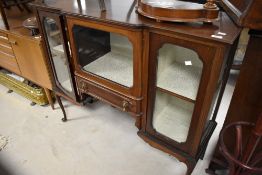An early 20th Century mahogany display cabinet having central breakfront glazed section over