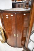 A 19th Century mahogany bow fronted corner cabinet