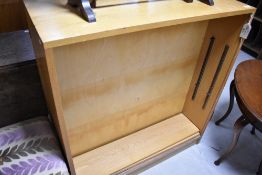 A vintage lightwood bookshelf with additional side door storage