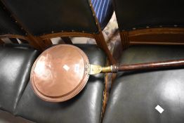A traditional copper warming pan