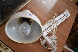 A clamp mounted angle poise desk lamp