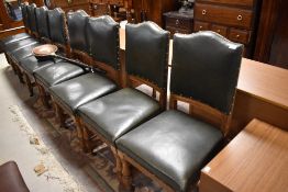A set of eight Victorian oak and green leather dining or gallery chairs