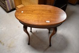 An early 20th Century oak and mahogany oval occasional/coffee table, approx. 67 x 45cm