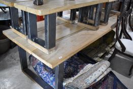 A large three plank oak and steel framed dining table, along with four similar bench seats, suitable