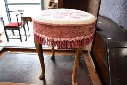 An early to mid 20th Century dressing table stool having circular woolwork top
