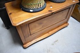 A vintage pine bedding/storage box having lift drop and drop front, width approx. 95cm
