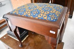 A traditional mahogany piano stool, having woolwork seat , and some sheet music books