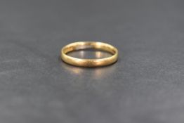 An 18ct gold band, of plain rounded form, marked 18 with hallmarks, ring size N-O, 2.6g