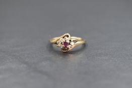 A 9ct gold ruby and cubic zirconia cluster ring, the central marquise cut ruby flanked by three