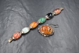 A Mexican silver articulated bracelet having six mixed agate cabochon oval stones in silver mounts