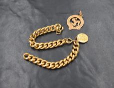 A broken 9ct gold curb chain bracelet with small 18ct gold charm and a Manx triskelion pendant