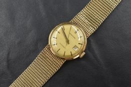 A lady's 9ct gold Longines automatic wrist watch having a baton numeral dial with date aperture on a