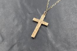 A 9ct rose gold cross pendant, having engraved decoration on a later 9ct gold open link chain,