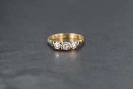 WITHDRAWN An 18ct gold diamond trilogy ring, the graduated diamond chips in illusion settings,
