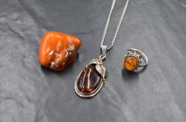 Three pieces of Baltic amber jewellery including a silver ring with oval amber cabochon, a oval