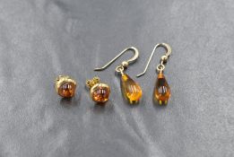 A pair of 9ct gold amber stud earrings, of circular form having a gold surround, marked 375 along