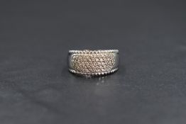 An 18ct white gold diamond set band, the five rows of round cut diamonds set within an oval panel to