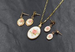 A 9ct gold paper link chain having enamelled rose pendant with two pairs of matched earrings, marked