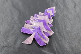 A Lea Stein of Paris laminated celluloid Christmas tree brooch in shades of purple