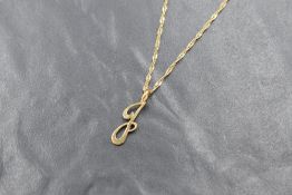 A yellow metal initial J pendant and 9ct gold chain, the pendant being unmarked and the chain marked