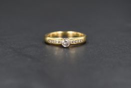 An 18ct gold and diamond solitaire ring having a bezel set brilliant cut diamond approx 0.15ct