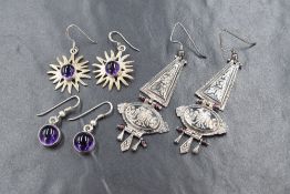 Three pairs of white metal earrings stamped 925, one pair of chandelier form bearing enamelled