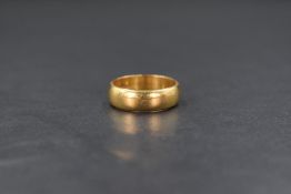 A 22ct gold band, of plain form, marked 22 with hallmarks, ring size L, 6.1g