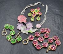 A Swarovski enamel and diamante necklace in shades of pink and green on a grey cord loop, along with